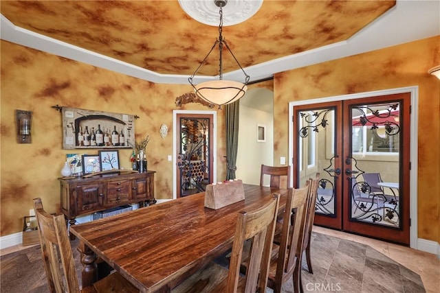 dining room featuring french doors and baseboards