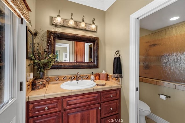 full bath with a shower with shower door, vanity, and toilet