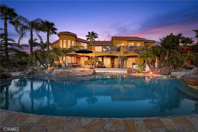 pool at dusk with an outdoor pool