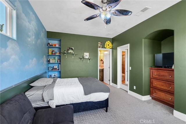 carpeted bedroom featuring a ceiling fan, visible vents, and baseboards