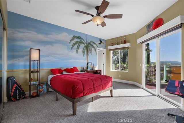 carpeted bedroom featuring access to outside, a ceiling fan, and baseboards