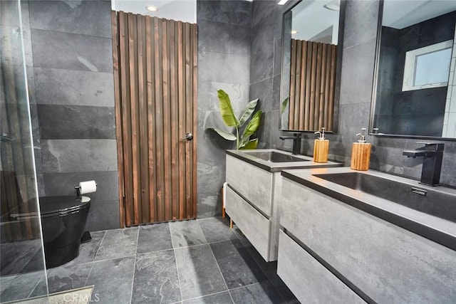 bathroom with vanity, toilet, and tile walls