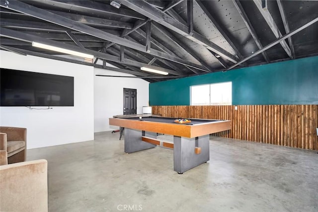 rec room featuring concrete floors, wood walls, billiards, and vaulted ceiling