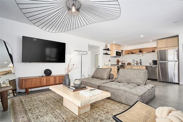 living room with concrete floors and sink