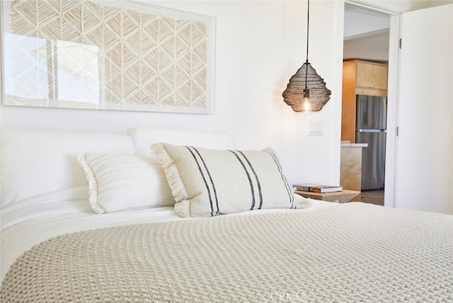 bedroom with stainless steel refrigerator