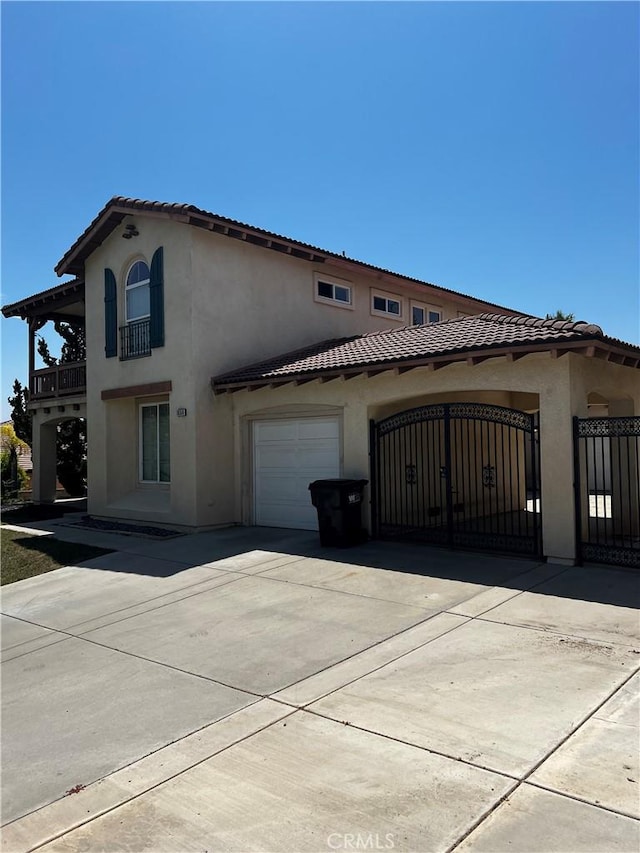 view of property exterior with a balcony and a garage