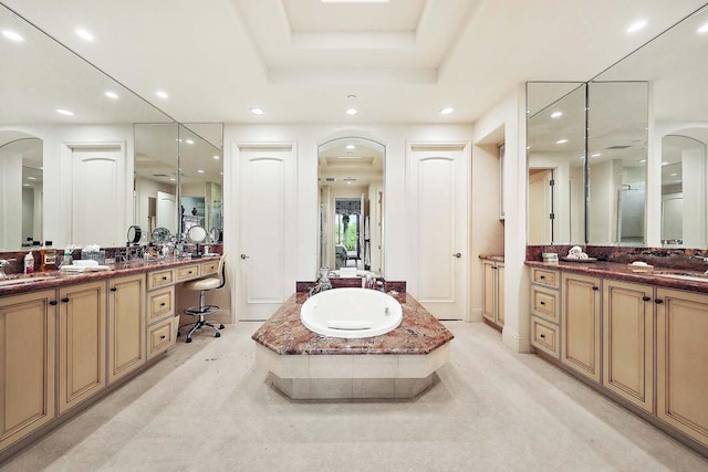 bathroom featuring vanity and a bath