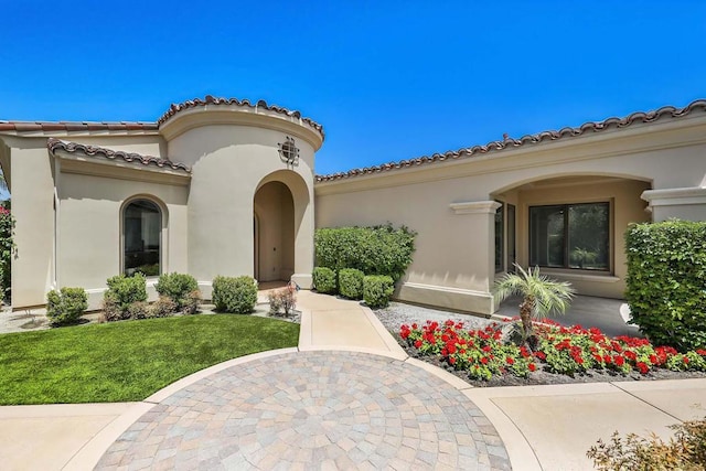 doorway to property featuring a lawn