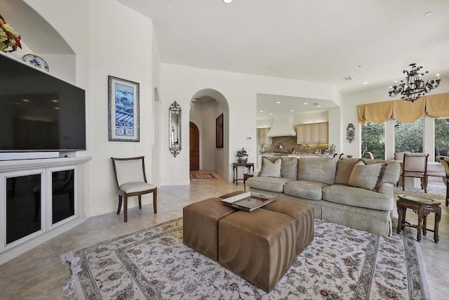 tiled living room with an inviting chandelier