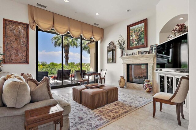 living area with light tile patterned floors and a premium fireplace