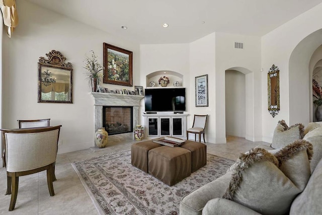 living room with light tile patterned flooring and built in features