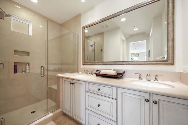 bathroom featuring vanity and a shower with shower door