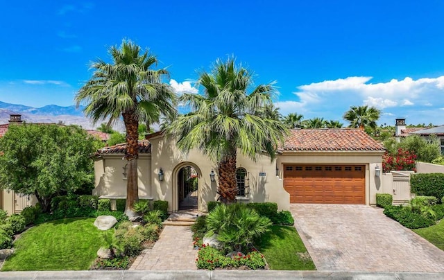 mediterranean / spanish-style home featuring a mountain view and a garage