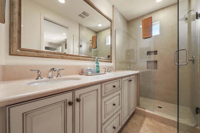 bathroom with vanity, tile patterned floors, and walk in shower