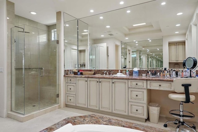 bathroom featuring vanity, a tray ceiling, and walk in shower