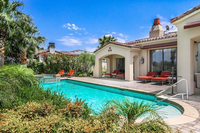 view of swimming pool with an in ground hot tub and a patio