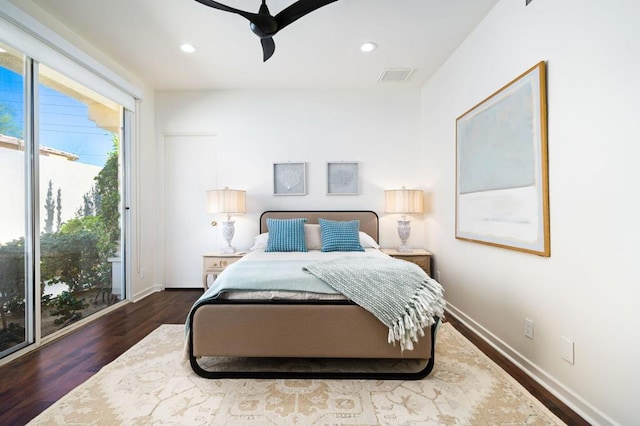 bedroom with ceiling fan, dark hardwood / wood-style floors, and access to outside