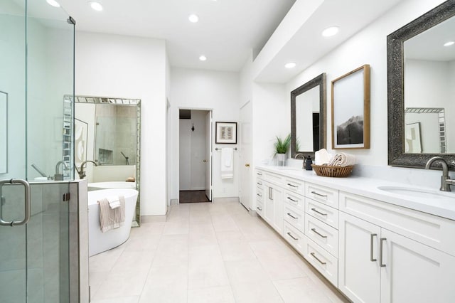 bathroom featuring tile patterned flooring, shower with separate bathtub, and vanity