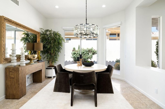 tiled dining space featuring a chandelier