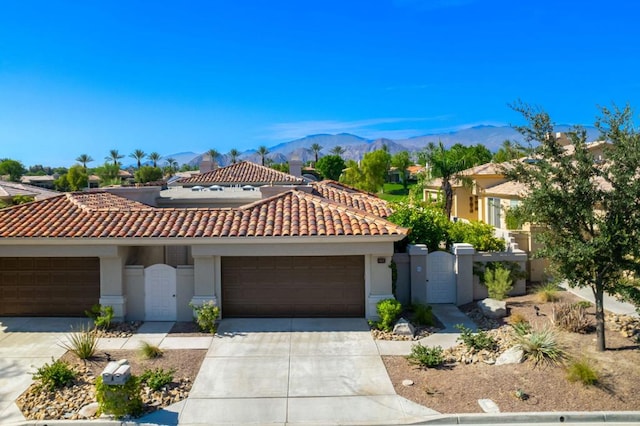 mediterranean / spanish-style house featuring a mountain view and a garage