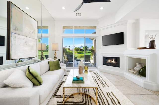 tiled living room with ceiling fan