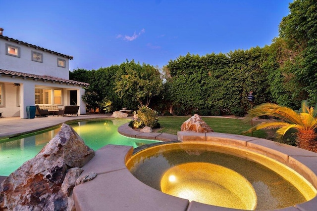 view of swimming pool with an in ground hot tub and a patio