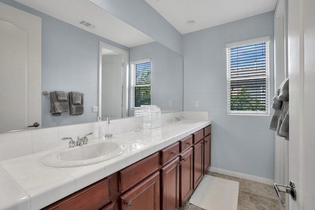 bathroom with tile patterned flooring, plenty of natural light, and vanity