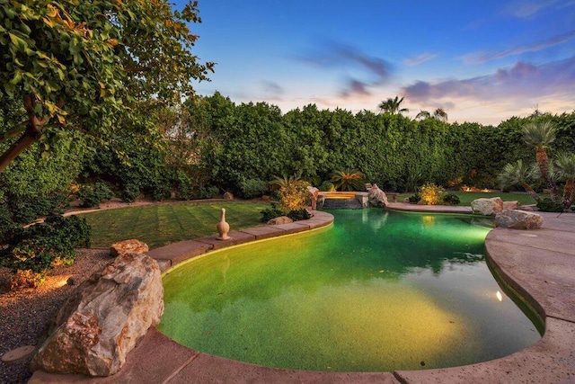 view of pool at dusk