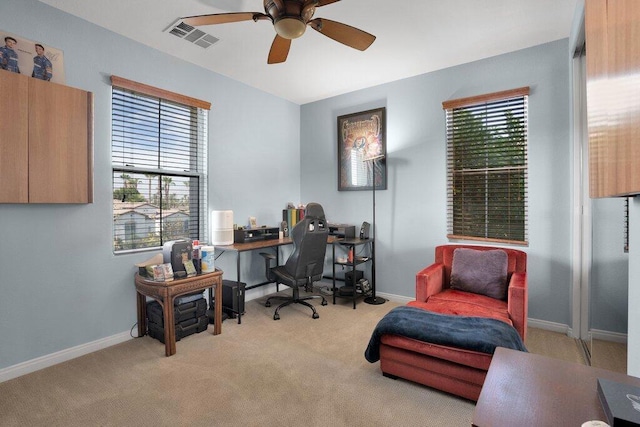 office with ceiling fan, light colored carpet, and a healthy amount of sunlight