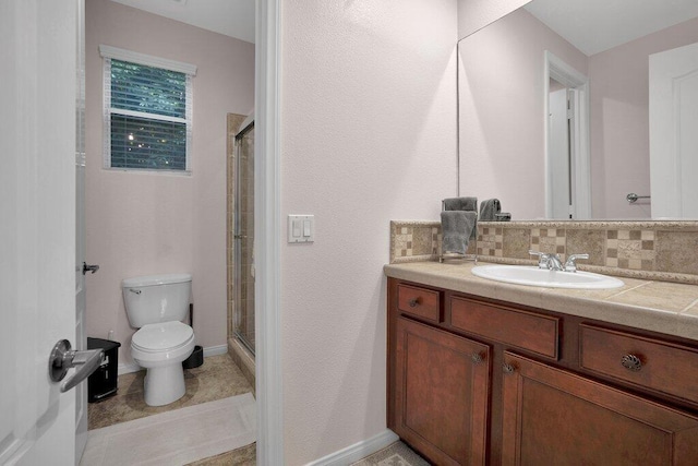 bathroom featuring vanity, tile patterned flooring, toilet, tasteful backsplash, and an enclosed shower