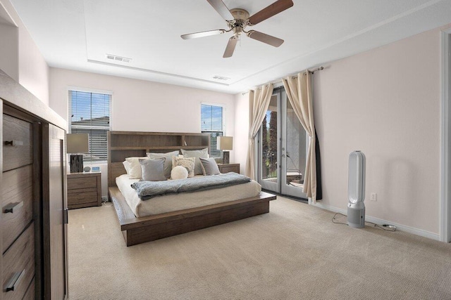 bedroom with ceiling fan, access to exterior, light colored carpet, and multiple windows