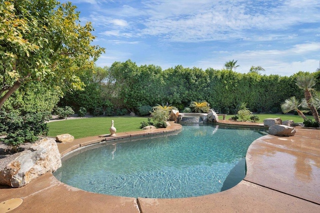 view of swimming pool with a lawn