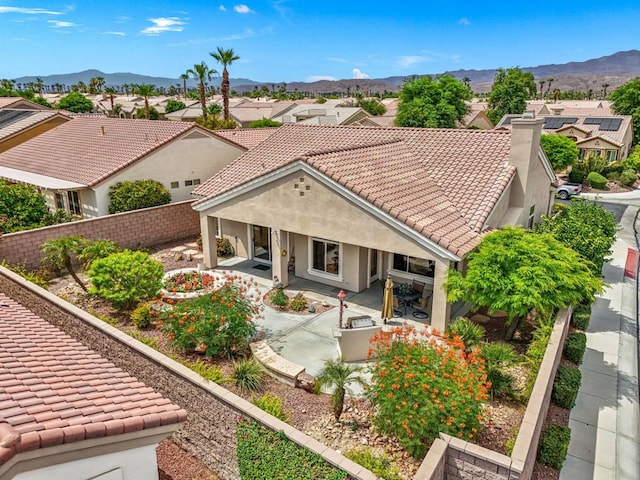 view of front of property featuring a mountain view and a patio area