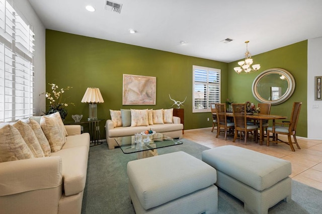 living room featuring a notable chandelier and light tile patterned floors