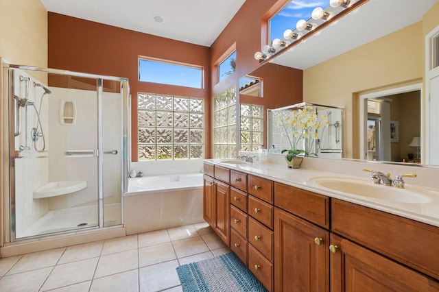 bathroom with tile patterned flooring, independent shower and bath, and vanity