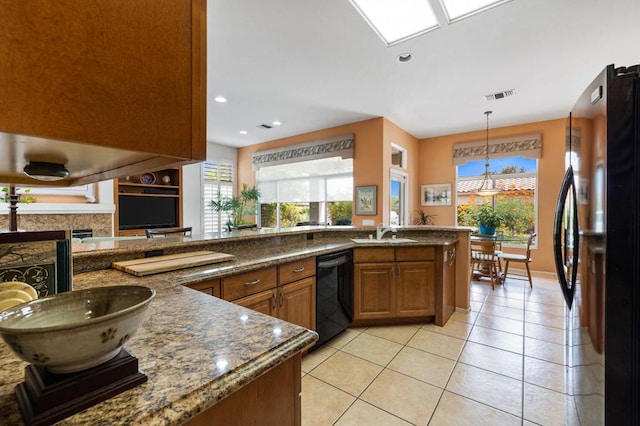 kitchen featuring dishwasher, light tile patterned flooring, sink, hanging light fixtures, and refrigerator