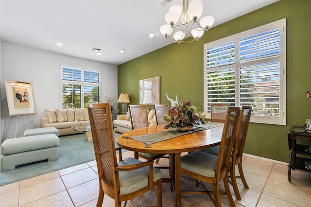 dining space featuring an inviting chandelier, plenty of natural light, and light tile patterned floors