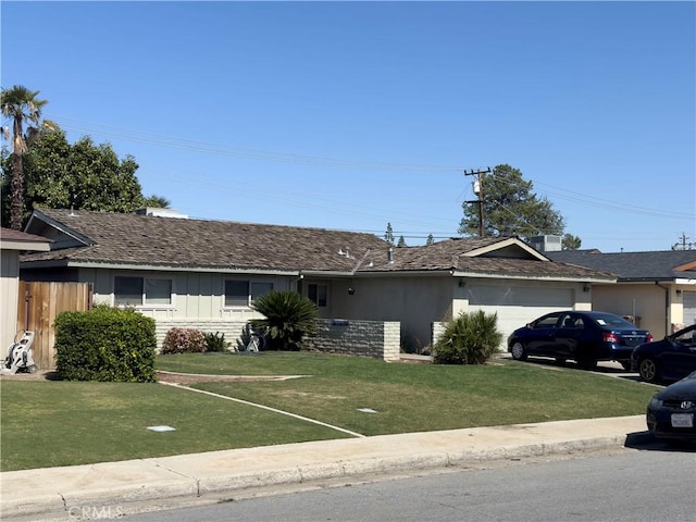 single story home with a garage and a front yard