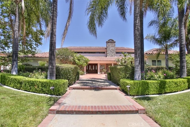 mediterranean / spanish-style house with a front lawn