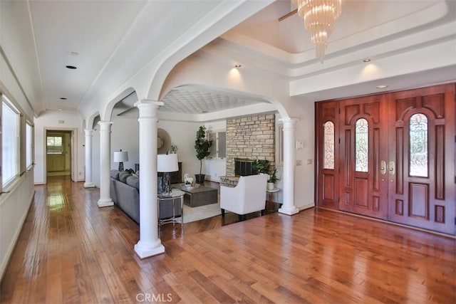 foyer entrance featuring hardwood / wood-style floors, plenty of natural light, and a raised ceiling