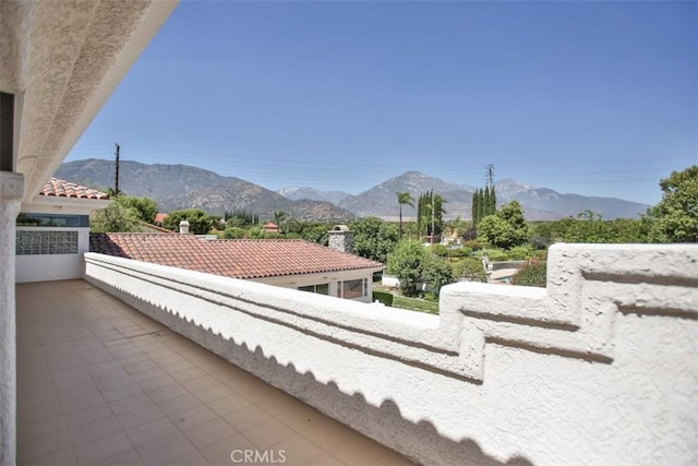 view of patio featuring a mountain view and a balcony