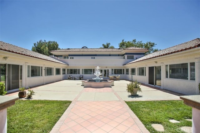 back of house with a patio area and a yard