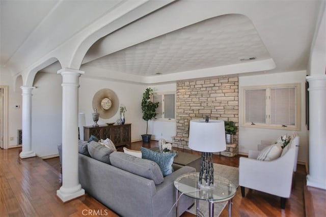 living room with a tray ceiling and hardwood / wood-style floors