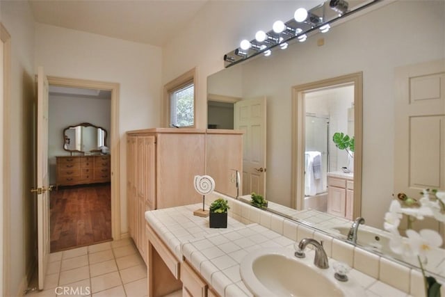 bathroom featuring tile patterned flooring and vanity