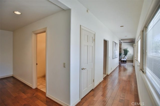 hallway with hardwood / wood-style floors