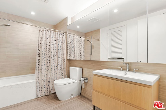 full bathroom with hardwood / wood-style flooring, vanity, toilet, and shower / bathtub combination with curtain