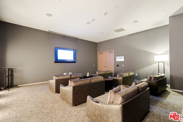 home theater room featuring light colored carpet