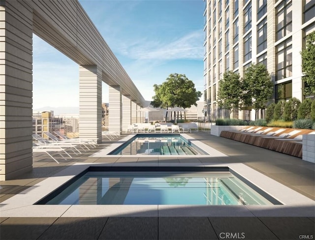 view of pool with a community hot tub and a patio area