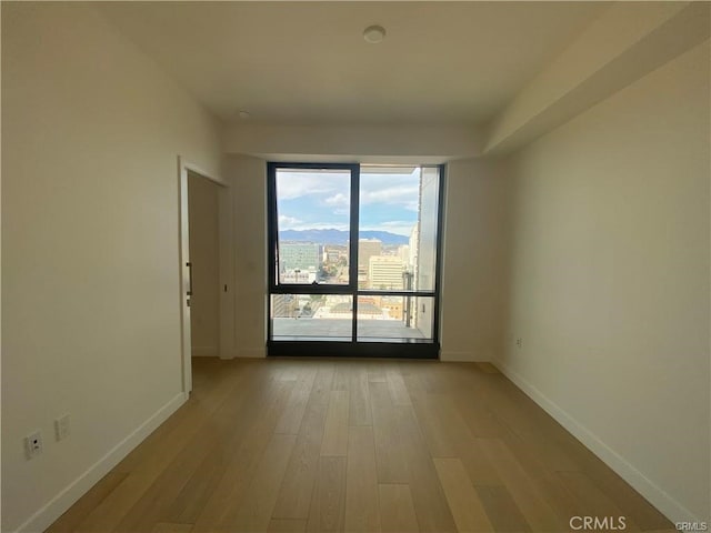 unfurnished room with light hardwood / wood-style floors