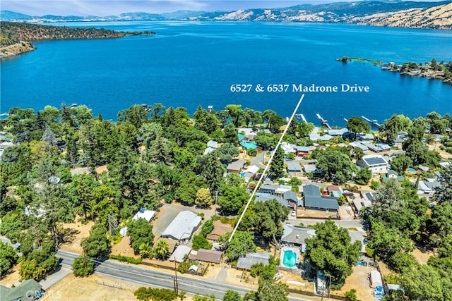 birds eye view of property with a water and mountain view